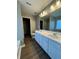 Bright bathroom featuring double sinks, white cabinetry, and modern fixtures at 108 Creekwood Trl, Acworth, GA 30102