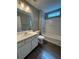 Clean bathroom featuring white vanity, a bathtub with shower, and modern fixtures at 108 Creekwood Trl, Acworth, GA 30102
