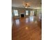 Spacious living room featuring gleaming hardwood floors, fireplace and large windows at 108 Creekwood Trl, Acworth, GA 30102