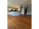 Open-concept living space with hardwood floors, kitchen, and staircase at 108 Creekwood Trl, Acworth, GA 30102