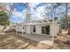 The backyard has a patio with pergola cover, a white wooden fence, and sliding glass doors to enter the house at 11270 Ridge Hill Dr, Alpharetta, GA 30022