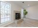 Cozy living room with fireplace and windows providing natural light and views at 11270 Ridge Hill Dr, Alpharetta, GA 30022