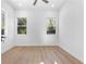 Bright bedroom features hardwood floors, white walls and natural lighting from several windows at 1247 Bridges Sw Ave # A, Atlanta, GA 30310