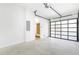 Spacious and well-lit garage with an interior door to the house and modern glass paneled door at 1247 Bridges Sw Ave # A, Atlanta, GA 30310