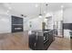 Modern kitchen with black marble island, stainless steel appliances and an electric fireplace at 1247 Bridges Sw Ave # A, Atlanta, GA 30310