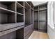 Custom walk-in closet with built-in shelving, drawers, and hardwood floor creates functional space at 1247 Bridges Sw Ave # A, Atlanta, GA 30310