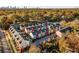 Aerial view of colorful townhomes and tree-lined streets, and city skyline at 160 Color Cir, Atlanta, GA 30317