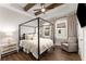 Bright bedroom with a four-poster bed, beamed ceiling, and a cozy sitting area at 160 Color Cir, Atlanta, GA 30317