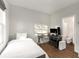 Bedroom featuring a simple design, a small bed and desk, and an adjacent bathroom at 160 Color Cir, Atlanta, GA 30317