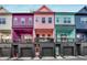 A row of modern townhouses with vibrant colors and garage parking in a residential neighborhood at 160 Color Cir, Atlanta, GA 30317