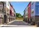 Street view of modern townhomes featuring attached garages and colorful exteriors at 160 Color Cir, Atlanta, GA 30317