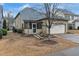 Back exterior of home with a screen door and two-car garage at 3919 Teal Cir, Powder Springs, GA 30127
