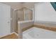 Bathroom showcasing a glass-enclosed shower and luxurious soaking tub at 3919 Teal Cir, Powder Springs, GA 30127