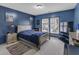 Stylish bedroom with cool blue walls, plush carpeting, and plenty of natural light at 3919 Teal Cir, Powder Springs, GA 30127