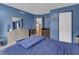 A blue bedroom features a dresser, walk-in closet, and neutral carpet at 3919 Teal Cir, Powder Springs, GA 30127