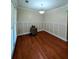 Dining room featuring hardwood floors, wainscoting, and ample natural light at 3919 Teal Cir, Powder Springs, GA 30127