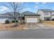 Ranch style home with a two-car garage, neutral paint and mature landscaping at 3919 Teal Cir, Powder Springs, GA 30127