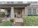 Inviting front porch with stone pillars, seating area, and manicured bushes offering a warm welcome to guests at 3919 Teal Cir, Powder Springs, GA 30127
