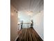 Hallway with elegant wood flooring, natural lighting and wrought iron bannister at 3919 Teal Cir, Powder Springs, GA 30127