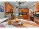 Open kitchen with stainless steel appliances, tile backsplash, and wood cabinets and a fruit arrangement on a table at 3919 Teal Cir, Powder Springs, GA 30127