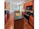 Well-lit kitchen with cherry wood cabinets, granite countertops, and stainless steel appliances at 3919 Teal Cir, Powder Springs, GA 30127