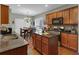 Modern kitchen with stainless steel appliances, granite counters, tile backsplash, wood cabinets and kitchen island at 3919 Teal Cir, Powder Springs, GA 30127