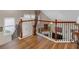 A beautiful landing with hardwood floors, and a decorative iron railing at 3919 Teal Cir, Powder Springs, GA 30127