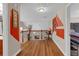 Spacious landing with hardwood flooring, an ornate iron railing, and unique wall art at 3919 Teal Cir, Powder Springs, GA 30127