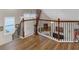 A beautiful landing with hardwood floors, and a decorative iron railing at 3919 Teal Cir, Powder Springs, GA 30127