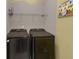 Laundry room featuring front load washer and dryer, shelving, and modern decor at 3919 Teal Cir, Powder Springs, GA 30127