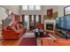 Inviting living room with a fireplace, large windows, and an elegant staircase for a warm, welcoming atmosphere at 3919 Teal Cir, Powder Springs, GA 30127