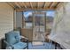 Screened porch, featuring a chair, welcome mat and view of the back yard at 3919 Teal Cir, Powder Springs, GA 30127