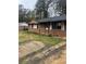 A single-story brick home with a dark roof, white shutters, and a compact front yard at 8947 Yarmouth Dr, Jonesboro, GA 30238