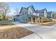 Modern two-story home with a covered front porch and a long driveway on a sunny day at 1247 Bridges Sw Ave # B, Atlanta, GA 30310