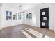 Bright living room with hardwood floors, a contemporary light fixture, and natural light from three windows at 1247 Bridges Sw Ave # B, Atlanta, GA 30310
