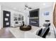 Cozy living room featuring a fireplace, modern decor, comfortable seating, and bright windows at 1247 Bridges Sw Ave # B, Atlanta, GA 30310