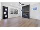 Living room with sleek fireplace and hardwood floors, featuring ample natural light from several windows at 1247 Bridges Sw Ave # B, Atlanta, GA 30310