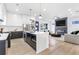 Open-concept living space with island seating, modern cabinets, stainless appliances, and adjacent living room at 1247 Bridges Sw Ave # B, Atlanta, GA 30310