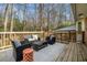 Relax on this home's back deck featuring stylish outdoor furniture and views of the trees at 1677 Foresta Ct, Atlanta, GA 30341