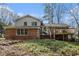 View of the home's back exterior showing the brick, siding, deck and stairs to the backyard at 1677 Foresta Ct, Atlanta, GA 30341