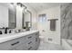 Modern bathroom with double vanity, updated fixtures, white countertops, and a separate shower and bathtub at 1677 Foresta Ct, Atlanta, GA 30341
