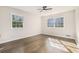 Bright and airy bedroom showcasing hardwood floors, a ceiling fan, and windows for plenty of natural light at 1677 Foresta Ct, Atlanta, GA 30341