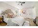 Bright primary bedroom with stylish decor, a comfortable bed, a ceiling fan, and ample natural light at 1677 Foresta Ct, Atlanta, GA 30341