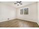 Spacious bedroom features wood floors, a ceiling fan, and a large window offering natural light and a comfortable space at 1677 Foresta Ct, Atlanta, GA 30341