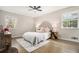 Serene bedroom featuring a plush bed with decorative pillows, a ceiling fan, and windows for natural light at 1677 Foresta Ct, Atlanta, GA 30341