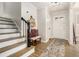 Inviting foyer with wood floors, a stylish bench, and a staircase leading to the upper level at 1677 Foresta Ct, Atlanta, GA 30341