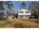 Traditional front exterior with brick and siding, complemented by mature landscaping and blue shutters at 1677 Foresta Ct, Atlanta, GA 30341