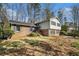 Charming front exterior with brick and siding, well-manicured lawn, and shuttered windows at 1677 Foresta Ct, Atlanta, GA 30341