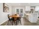 Modern kitchen with white cabinets, stainless steel appliances, and an adjacent dining area at 1677 Foresta Ct, Atlanta, GA 30341