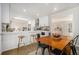 Bright kitchen with white cabinetry, bar seating, and open layout connected to the dining area at 1677 Foresta Ct, Atlanta, GA 30341